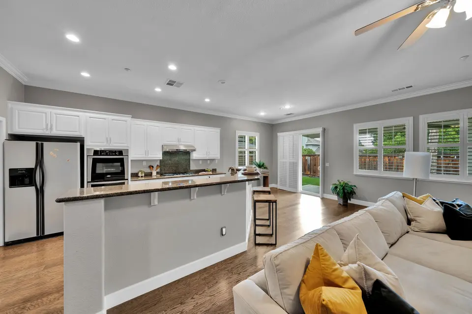 Kitchen breakfast bar, stainless appliances and dining nook seen from the family room.