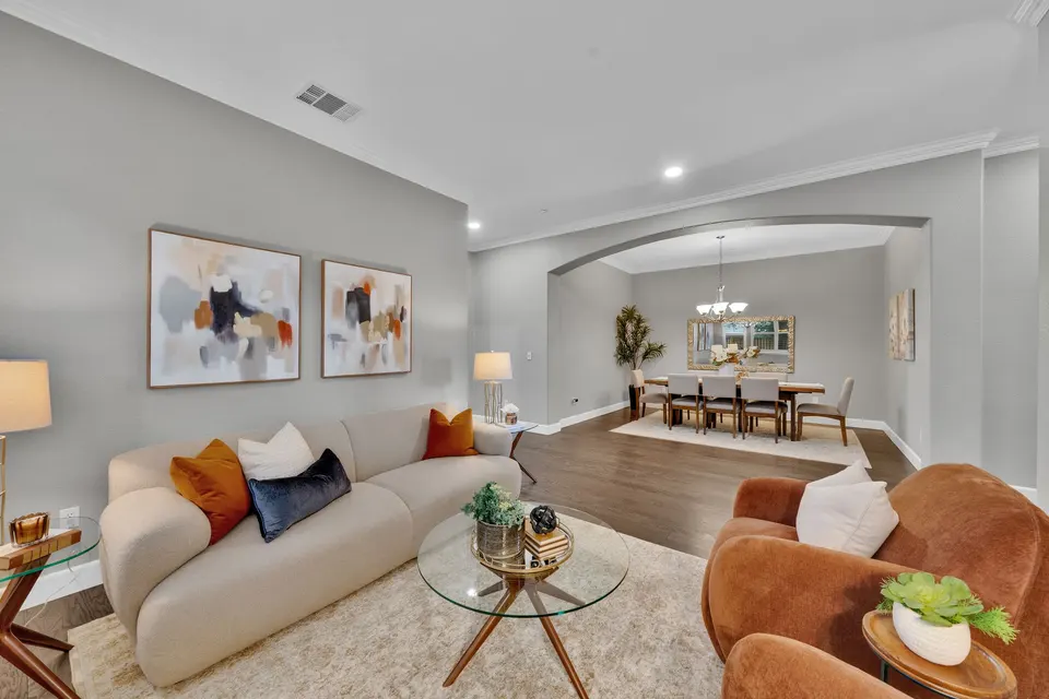 Front living room seating area, shuttered windows and the dining room beyond.